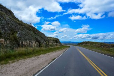 Route in Pampa de Achala, Quebrada del Condorito  National Park,Cordoba province, Argentina clipart