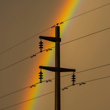 Electric line in the storm rainbow landscape, La Pampa Province, Patagonia , Argentina. clipart