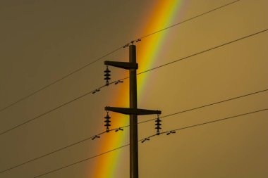 Electric line in the storm rainbow landscape, La Pampa Province, Patagonia , Argentina. clipart