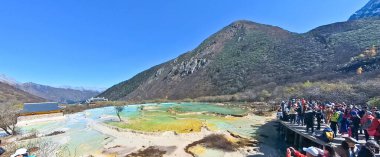 China, Sichuan, 01.01.2025 tourists visiting Huanglong valley which is made up of colorful lakes snow capped peaks green forest and glaciers  clipart