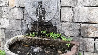 Bir düğün yeri beyaz sütunlar, turuncu ve beyaz çiçekler ve büyük, dekoratif bir haçla süslenir. 