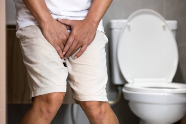 Asian middle aged man suffering from dysuria,acute cystitis, urinary tract infection,people patient holding crotch in toilet,prostate problems,inflammation of urethra,painful or difficult urination clipart