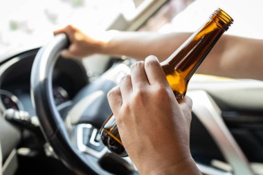 Sarhoş adam elinde bira şişesi, Asyalı erkek motorlu taşıt kullanırken alkol alıyor, araba kazası riski veya tehlikesi var içki içmeyin, araba kullanmayın, önleme, trafik kazası kurbanlarının azaltılması