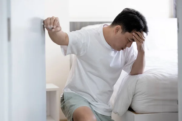 stock image Dizzy man having positioning vertigo,sensation of whirling,spinning around and loss of balance,vertigo after wake up,stagger and collapse beside the bed,symptom of giddiness,dizziness attack standing