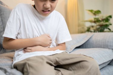 Child boy have flatulence,colic,indigestion,severe pain in abdomen caused by intestinal gas or obstruction in intestines,abdominal discomfort,Dyspepsia,difficulty in digesting food,digestive disorders clipart