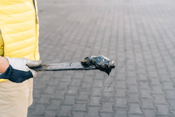 Stock image A worker smearing trailer fifth wheel coupling with lubricant oil. Semi-truck mechanical maintenance . High quality photo