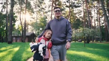 Baba ve çocuk bir ormanda kameraya doğru yürüyorlar. Babası ve 5 yaşındaki kızı yürüyüş yapıyor, hafta sonunu birlikte geçiriyorlar. Yüksek kalite 4k görüntü