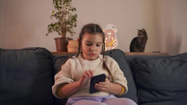 Young Girl Engaged Smartphone Sitting Couch — Stock Video