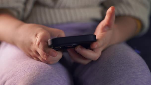 Close Young Childs Hands Holding Smartphone Deeply Engaged — Stock Video