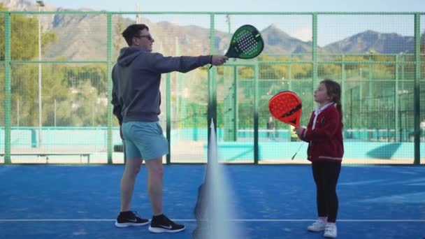 Man His Daughter Share Playful Moment Paddle Tennis Court Exchanging — Stock Video