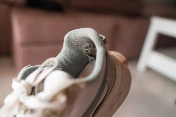 stock image Close-up of well-used sneakers, highlighting the wear and tear, representing the underconsumption core trend focused on sustainability and mindful consumption. High quality 4k footage