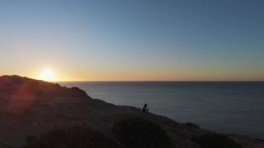 Sakin Algarve kıyı şeridinde batan güneşin büyüleyici manzarası. Doğal güzellik ve huzurun mükemmel bir karışımı. Yüksek kalite 4k görüntü