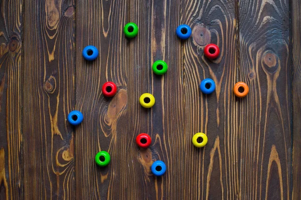 multicolored round wooden constructor detail on a wooden table