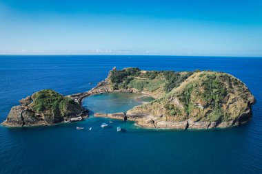 Parlak bir yaz gününde Ilheu de Vila Franco do Campo 'nun havadan görünüşü turkuaz gölünü ve volkanik güzelliğini Sao Miguel, Azores, Portekiz' de sergiliyor.