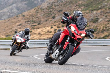 Motosikletli keskin bir viraj alıyor. Fotoğraf 9 Eylül 2020 tarihinde İspanya 'nın Avila ilinin Navalmoral limanında çekildi.