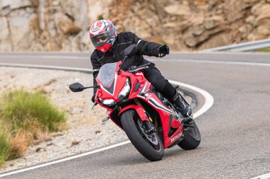 Motosikletli keskin bir viraj alıyor. Fotoğraf 9 Eylül 2020 tarihinde İspanya 'nın Avila ilinin Navalmoral limanında çekildi.