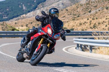 İspanya 'nın Avila ilinde Navalmoral limanında motosikletinin üzerinde oturan bir adam. Fotoğraf Ağustos 2020 'de çekildi