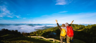 Young couple Camping Hiking Journey Travel Trek Concept, Holiday travel,  Travel relax, Natural Touch countryside, in Thailand. clipart