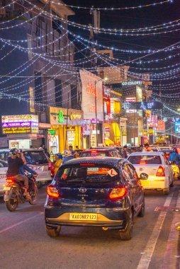 Brigade Road Bengaluru Karnataka India September 11 2024 Busy lit up streets and shops and buildings at Brigade Church Street and MG road in Bangalore Bengaluru at night with traffic and pedestrians clipart