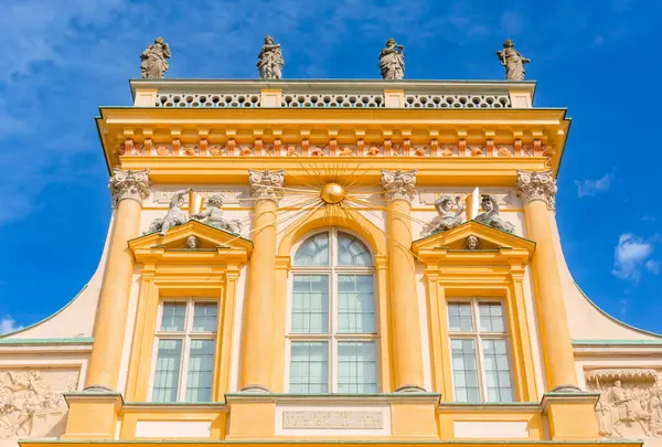 stock image Warszawa, Poland - April 18, 2022: Focus on View of the central facade of the Royal Wilanow Palace in Warsaw, Poland. Spring in the park, magnolia blossoms