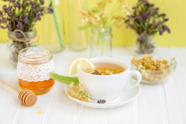 Limon ve doğal bal ile ıhlamur çiçeklerinden sıcak çay, vitamin ve güçlü bağışıklık için sağlıklı ikramlardır.