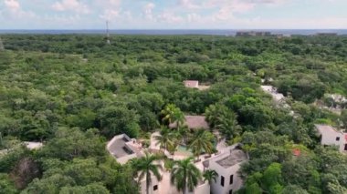Meksika 'da bir ormanın ortasında lüks bir havuz üzerinde hareket eden yavaş çekim hava manzarası.