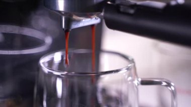 close-up of Coffee foam. espresso crema comes out of the fully automatic coffee machine, Making the coffee machine into a cup.