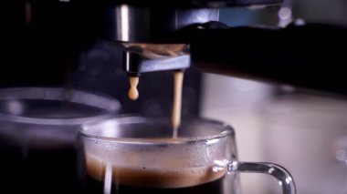 close-up of Coffee foam. espresso crema comes out of the fully automatic coffee machine, Making the coffee machine into a cup.