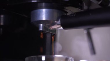 close-up of Coffee foam. espresso crema comes out of the fully automatic coffee machine, Making the coffee machine into a cup.