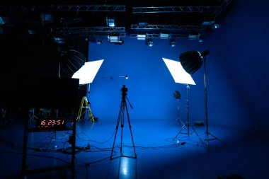 Professional video studio behind-the-scenes video footage behind-the-scenes silhouette production photography with a focus on camera and studio equipment.