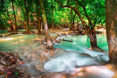 Hot Springs Onsen Natural Bath is Surrounded by red-yellow leaves. In fall leaves, Waterfall among many foliages, In fall leaves Leaf color change
