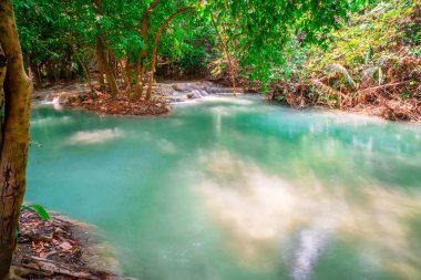Hot Springs Onsen Natural Bath is Surrounded by red-yellow leaves. In fall leaves, Waterfall among many foliages, In fall leaves Leaf color change