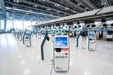 BANGKOK, THAILAND - 21 Ocak 2023: Suvarnabhumi Uluslararası Havalimanı 'ndaki check-in gişelerinde self-servis kontrol makinesi