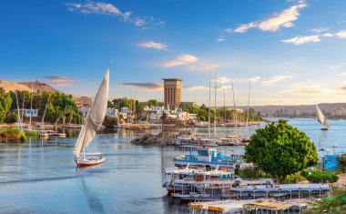 Beautiful view of the sailboats in the Nile and traditional villages of Aswan city, Egypt.