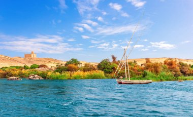 The Nile view with the old sailboats in the Aswan desert, Egypt.