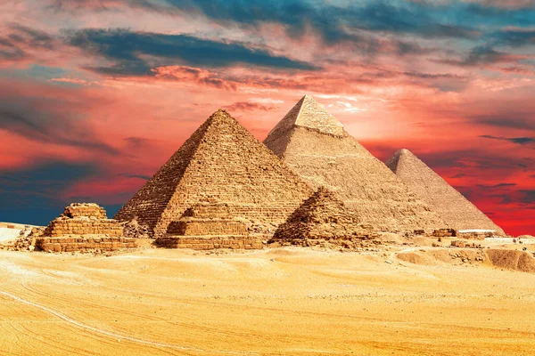 The Pyramids of Egypt in the sands of Giza desert, sunset view, Egypt.