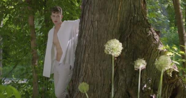 Young Man Light White Clothes Comes Out Tree Green Flowering — Video Stock