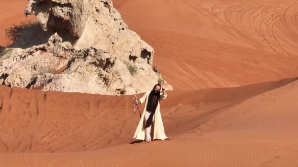 Man Shamans Clothes Walks Sand Desert Staff His Hands Drone — Stock Video