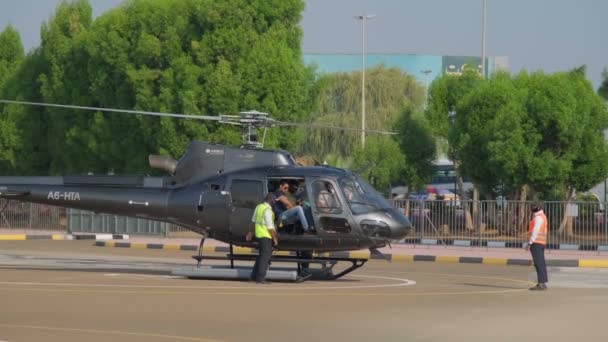 ドバイ Uae 2023 人々は飛行場に立つ小さな民間ヘリコプターから出る スローモーション — ストック動画