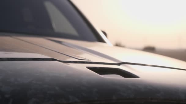 Symbol Drogiego Luksusowego Samochodu Zjeżdża Maski Tle Wieczornego Nieba Piaszczystej — Wideo stockowe