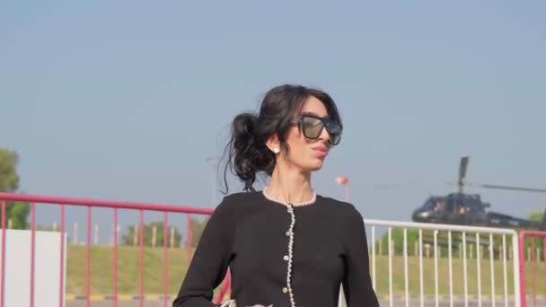 Young Woman Elegant Dress Walks Airfield Background Flying Private Helicopter — Stock Video