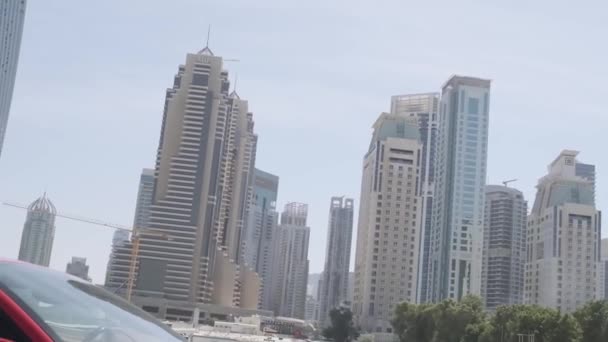 Red Expensive Sports Car Stands Sand Embankment Backdrop Dubais Skyscrapers — Stock Video