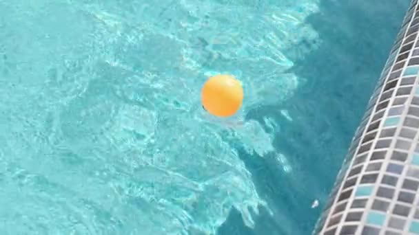 Orange Ball Floats Waves Outdoor Private Pool Sunny Summer Day — Stock Video