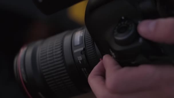 Der Fotograf Hält Die Kamera Der Hand Und Justiert Sie — Stockvideo
