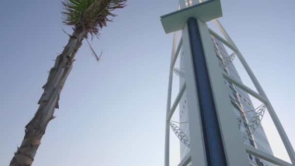 Burj Arab Skyscraper United Arab Emirates Surrounded Palm Trees Cloudless — Stock Video