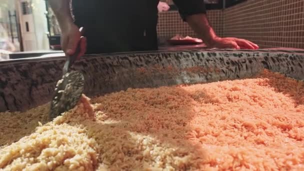 Chef Stirs Steaming Rice Large Pilaf Cauldron Slotted Spoon Slow — Stock Video