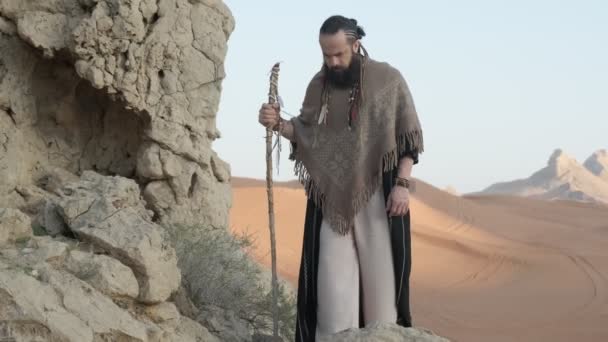 Young Bearded Shaman Staff His Hand Walks Rocks Middle Desert — Stock Video