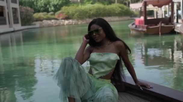 Relaxed Interracial Woman Dress Sits Bow Boat Passing Canal Dubai — Stock Video