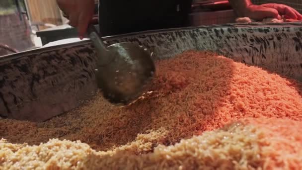 Chef Stirs Steaming Rice Large Pilaf Cauldron Slotted Spoon Slow — Stock Video
