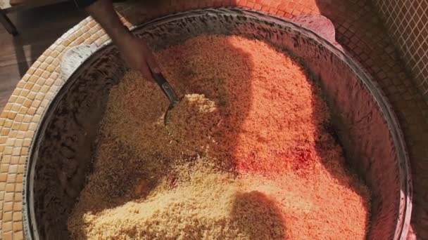 Chef Tosses Rice Slotted Spoon Large Cauldron While Cooking Pilaf — Stock Video
